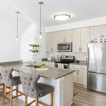 Fitted kitchen with island dining